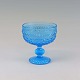 Skål på fod i 
lys blå 
dekoreret glas
Højde 13 cm 
Diameter 12 cm