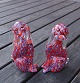 Murano 
kunstglas fra 
Italien, par 
siddende hunde 
med rød 
bundfarve og 
grå/sorte 
pletter. Øre, 
...