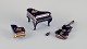 Limoges, France. Four porcelain musical instruments decorated with 22-karat gold leaf and ...