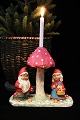 Old Christmas decoration in the form of a pair of elves standing under a 
mushroom...
