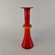 Vase i 
opalhvidt 
mundblæst glas 
med rødt 
overfang. Vasen 
kan også bruges 
som ...