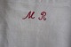 An old bag made of antique flax, with embroidery made by hand, and with a red signature ...