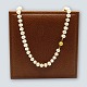Pearl 
jewellery.
A long pearl 
chain, with 
clasp of 14k 
gold.
Necklace l. 62 
cm.
Clasp dia. 1 
...