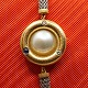 Ole Lynggaard 
gold jewellery.
Ole Lynggaard; 
'Uranus' clasp 
of 18k gold, 
set with pearl, 
...