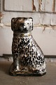 Antique piggy bank in ceramic in the shape of a small dog...