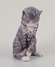 Erik Nielsen 
for Royal 
Copenhagen. 
Porcelain 
figurine of 
gray striped 
cat. 
Model number 
340. ...