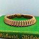 Armbånd af 14 
kt. guld. 
Monteret med 
kasselås samt 
sikkerhedslås. 
L. 19,4 cm. B. 
11,5 ...
