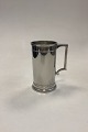 Just 
Andersen/Royal 
Copenhagen 
Krus, poleret 
tin No. 
2204/14. 
Måler 14,2 cm 
/ 5,59 in.
