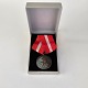 Dansk 
fortjenstmedalje 
i sterling sølv 
med teksten 11 
marts 1953 For 
God Tjeneste på 
forsiden og ...