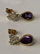 Gold earrings in 14 carat gold, inlaid amethyst and clear stones.