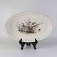 Ovalt ildfast 
fad i porcelæn 
med motiv af 
agerhøne på 
rede fra 
stellet 
Jagtstel. Nr. 
...