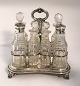 English sterling Platmenage with 7 crystal decanters (925). Length 19 cm. Height 
20 cm. Produced London 1831.