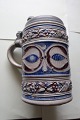 Antique mug with a lid of tin/pewter
Pottery
H: 17cm (see photo)
Stamped
In a very good condition