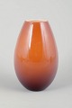 Peter Svarrer for Holmegaard“Cocoon” Vase, 20th Century.Mouth-blown vase in a warm orange ...