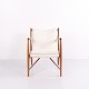 Lænestol designet af Finn Juhl i 1952. Stolen er udført i valnød og polstret med lyst stof. ...