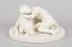 Gustavsberg, bisquitfigur.Fin bisquitfigur med motiv af et barn, der omfavner en hund. ...
