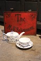 Decorative, old tea advertising sign in metal with hand-painted writing on a red background...