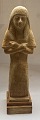 Egyptisk figur forestillende en shabti.På hovedet bæres en tripartite paryk og hænderne ...