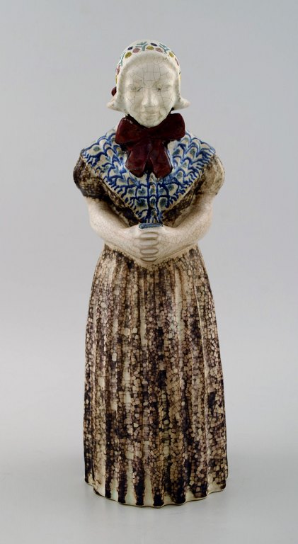 Michael Andersen Ceramics from Bornholm.
Large figure of woman with Songbook in national dress.
