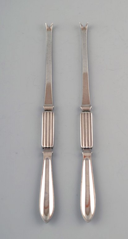 Two Georg Jensen Silver Bernadotte lobster forks.
