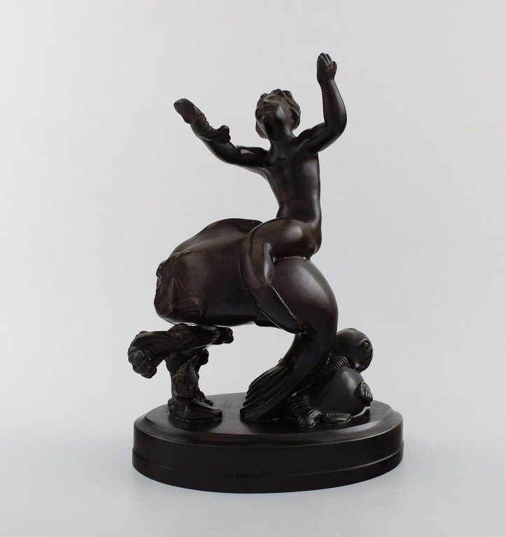 Just Andersen (1884-1943). Figure in light bronze in the form of a seaboy on 
fish.
