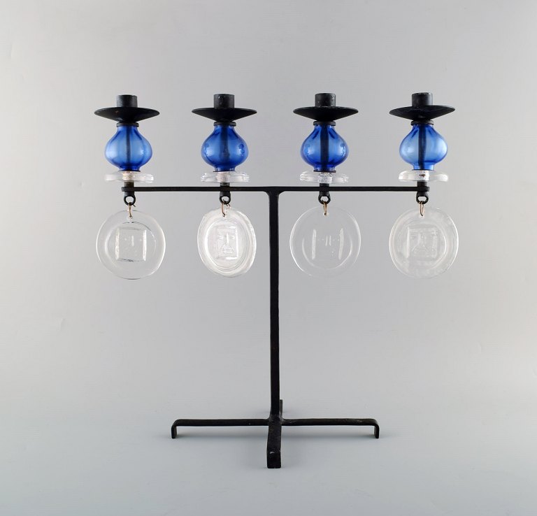 Erik Höglund for Kosta Boda, large candle holder in cast iron with mouth blown 
glass.

