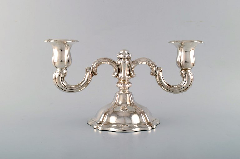 Two-armed neo rococo candlestick with curved arms in silver (830). 1930 / 40