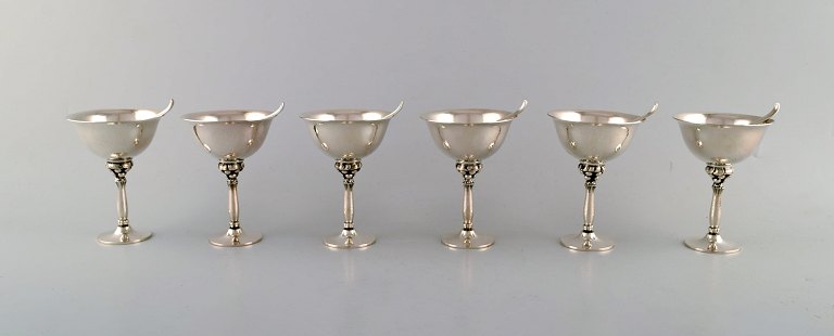 Harald Nielsen for Georg Jensen. A set of six cocktail glasses and six cocktail 
picks in hammered sterling silver. Dessin 479 A and 68 A.