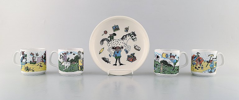 Rörstrand. Four cups and a plate in porcelain with Pippi Longstocking motifs. 
Late 20th century.