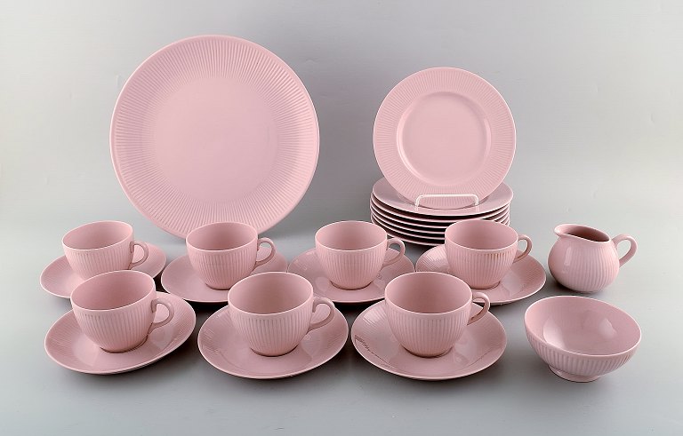 Arabia, Finland. Pink porcelain coffee set for seven people. Consisting of seven 
coffee cups with saucers, seven plates and a large round dish. 1960