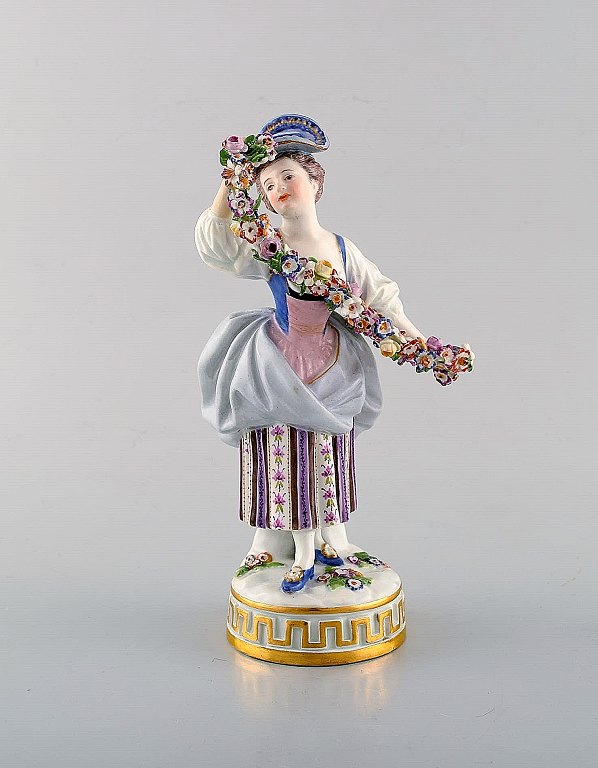 Meissen porcelain figurine. Woman in purple dress with flowers. Ca. 1900.