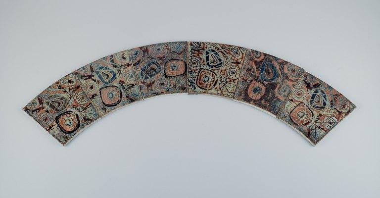 Royal Copenhagen, six Baca faience tiles with patterned glaze in brown, blue and 
green.