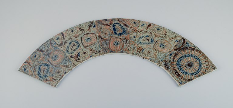 Royal Copenhagen, five Baca faience tiles with patterned glaze in brown, blue, 
green and sand colours.