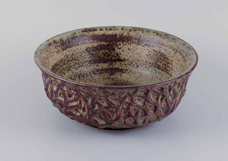 Axel Salto for Royal Copenhagen, large ceramic bowl designed with leaf patterns 
in relief.