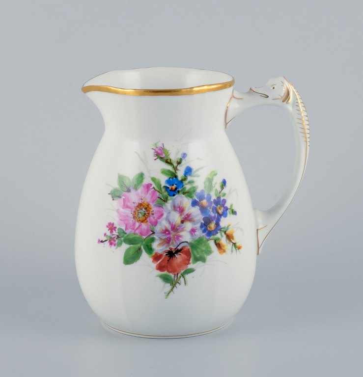 Bing & Grøndahl porcelain pitcher decorated with polychrome flowers and handle in the form of a seahorse.