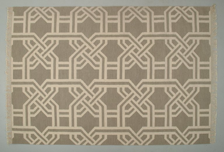 Swedish textile designer. Large handwoven carpet in pure wool. Gray base with white lines.