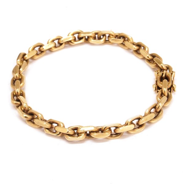 Anker armlænke i 8kt guld med kasselås og to sikkerhedslåse. L: 20cm. Ledstr. 
6x9mm. V: 26gr