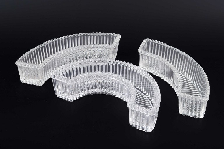 Baccarat, three curved glass trays.