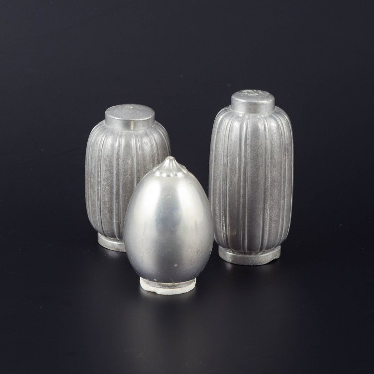 Just Andersen, Denmark
Set of three salt and pepper shakers in pewter, two with ribbed bodies and one 
with a smooth, egg-shaped form.