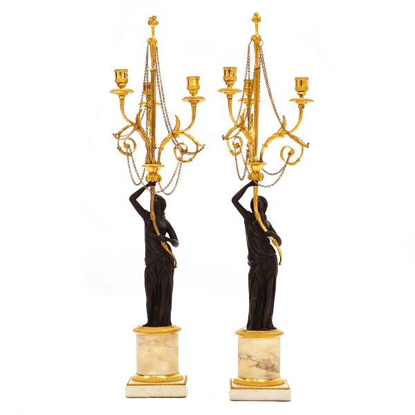 Pair of French firegilt bronze candelabra with marble base. France circa 1810. H: 73cm